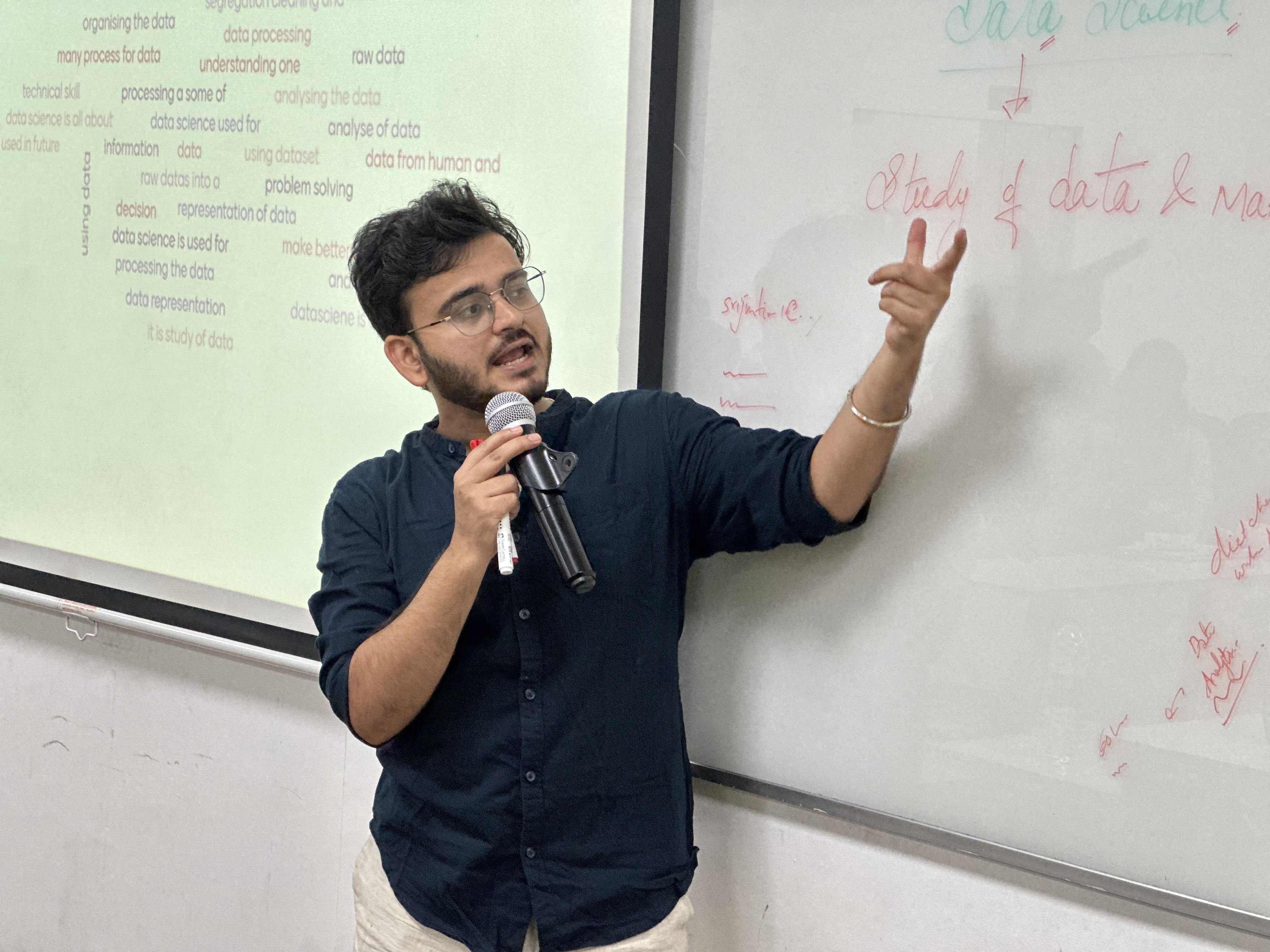 Srijan Tiwari speaking in front of a TIQWorld presentation